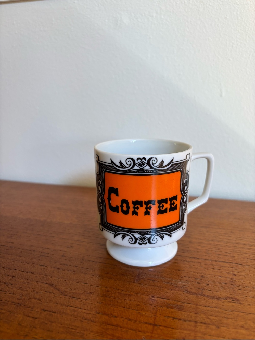 Vintage orange coffee mug with pedestal foot